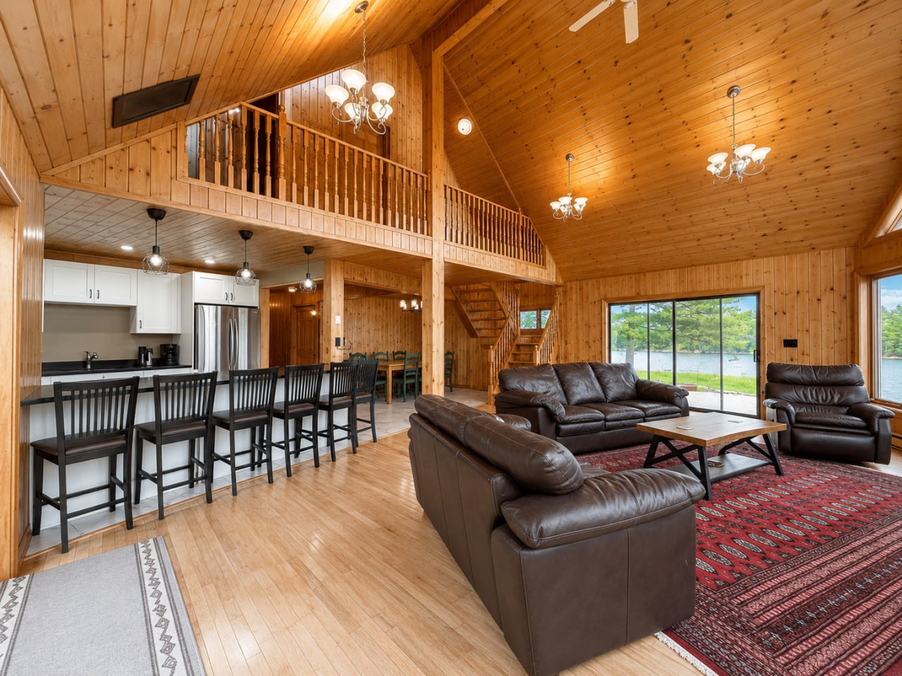 Guest house great room with loft above and leather seating